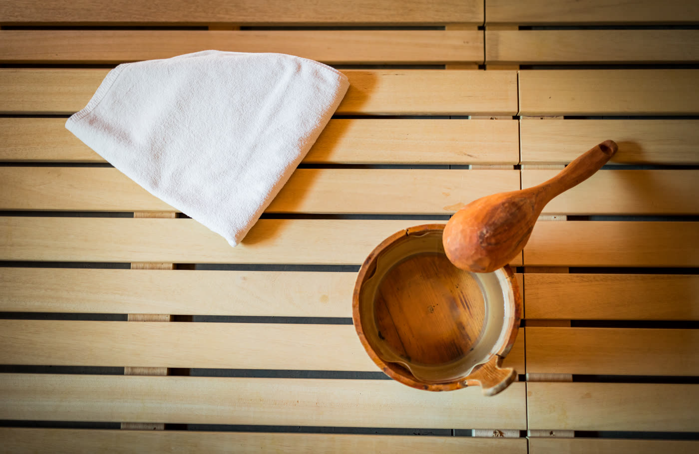 Sauna towel, bucket, and accessories for safe sauna use.